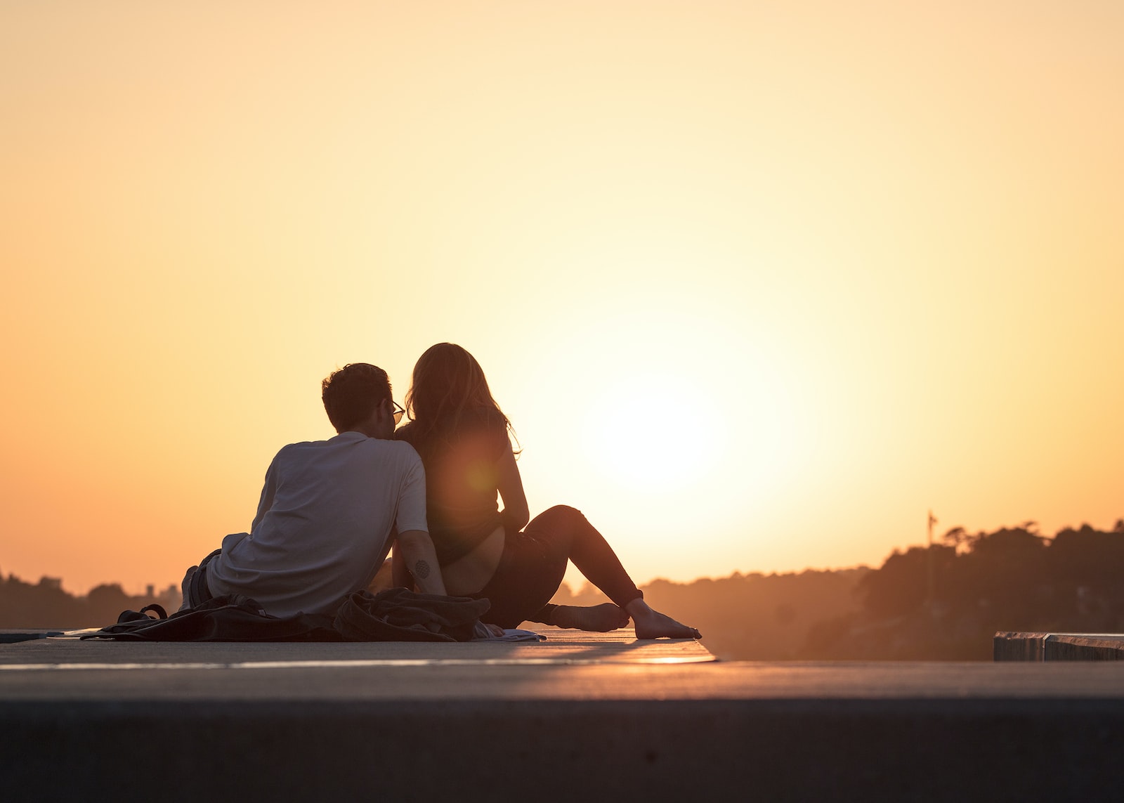 a man sitting at sunset